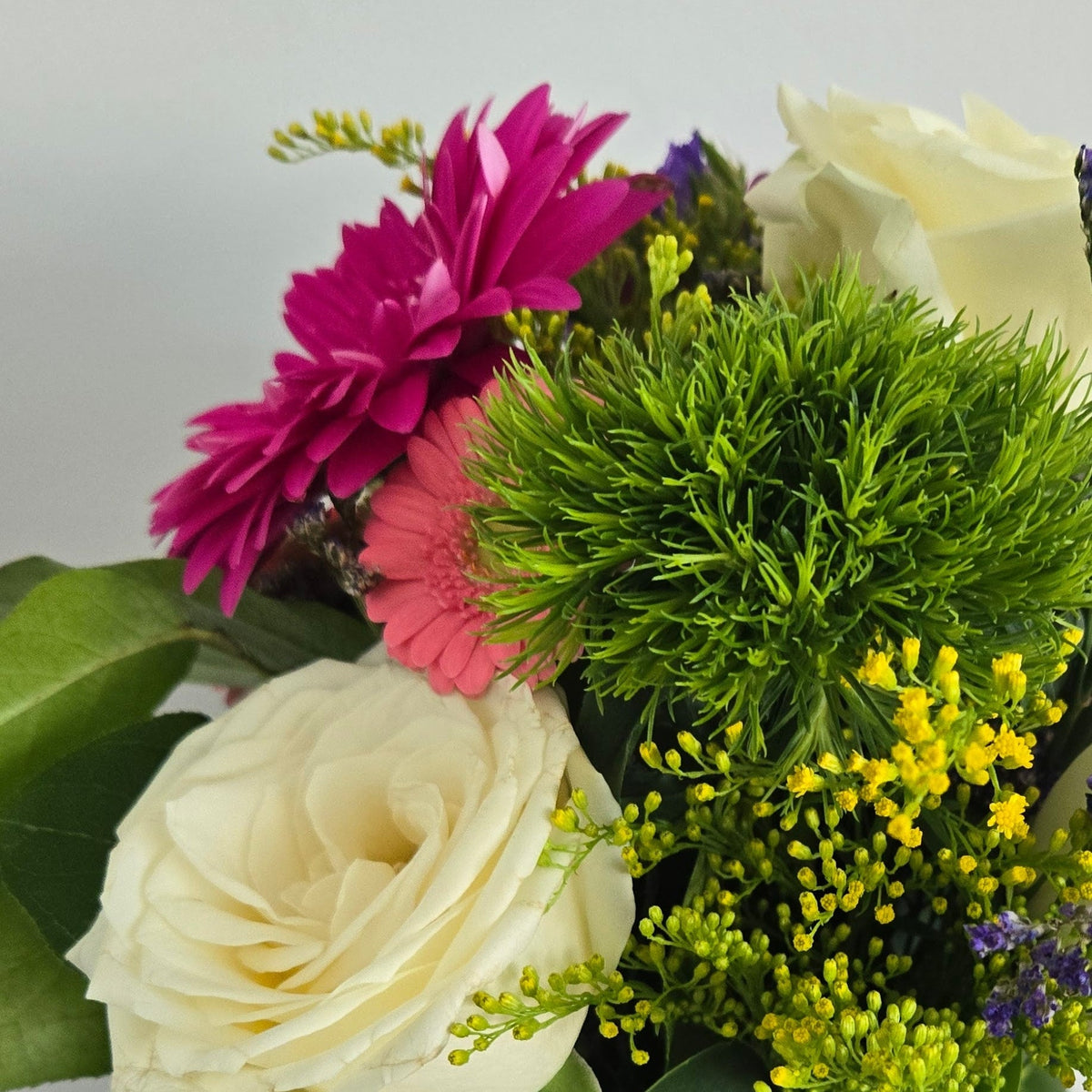 Florist choise bouquet with white roes gerbera daisies eucalyptus, green foliage hand tied with a satin bow. Delivery in Chilliwack Sardis and Vedder