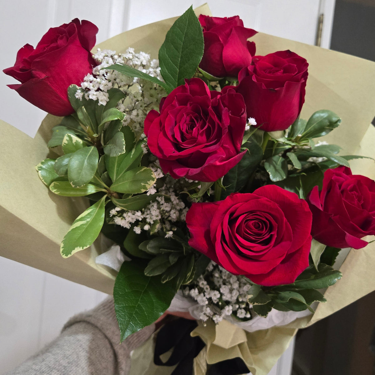 Bouquet of red roses with greenery Eucalyptus and babys breath, wrapped in korean paper for delivery in Chilliwack and garrison.