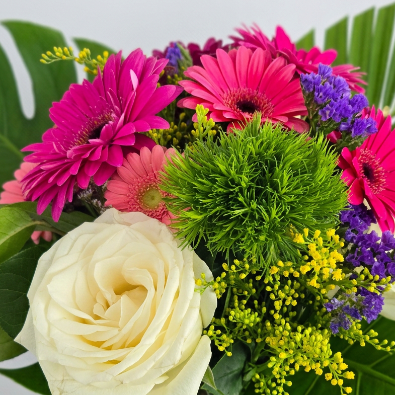 Florist choise bouquet with white roes gerbera daisies eucalyptus, green foliage hand tied with a satin bow. Delivery in Chilliwack Sardis and Vedder