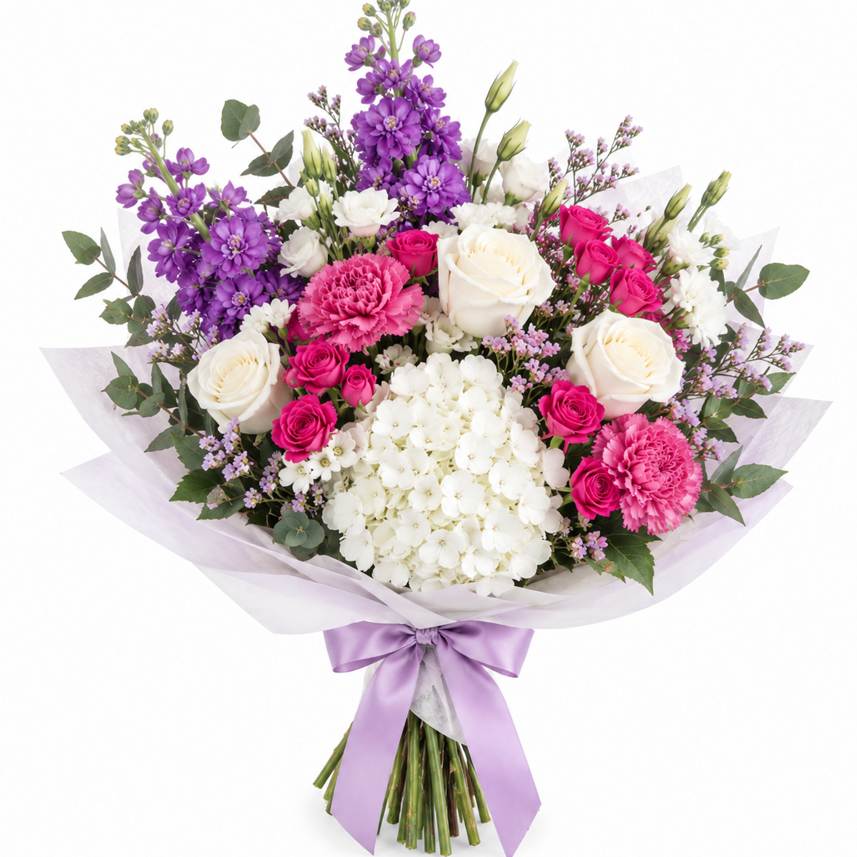 A vibrant mixed flower bouquet featuring white roses, pink carnations, purple delphiniums, and white hydrangeas, wrapped in white tissue paper with a light purple ribbon, set against a solid white background. Ready for delivery in Chilliwack, Vedder and Fairfield Island